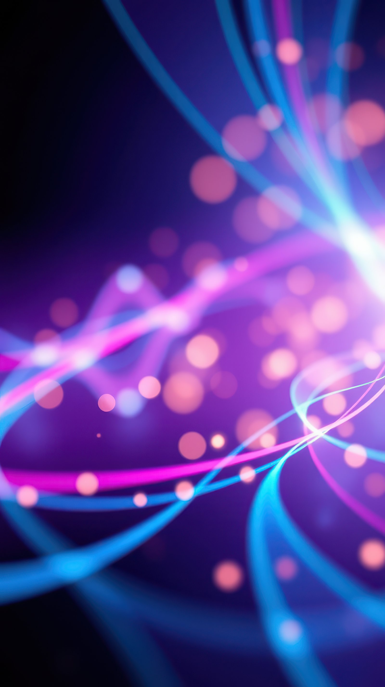 Colorful light trails create a vibrant abstract design with purple and blue hues during a dynamic display of energy